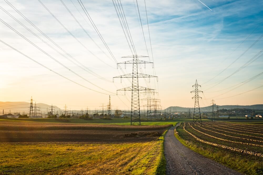 Industrial power lines running through large fields
